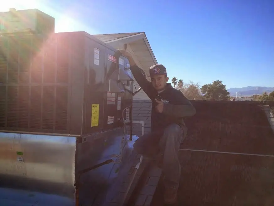 HVAC technician performing AC Tune-Up on a rooftop unit in Fanwood